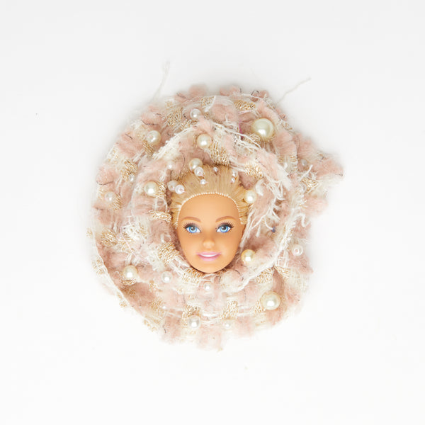 blond hair doll face on pink tweed fabric chanel style