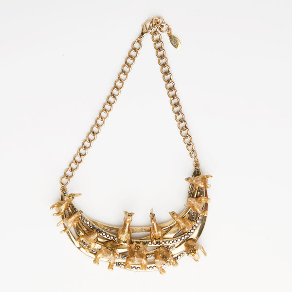 gold dinosaur necklace with gold rhinestones