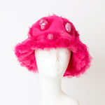 pink fluffy hat with pink dolls headpiece