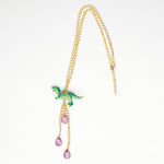 green dinosaur t rex  necklace  with gold chains purple crystal