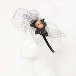 blond doll with eylashes fascinator headpiece