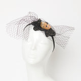 blond doll with eylashes fascinator headpiece