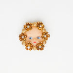 vintage doll face gold brooch with flower