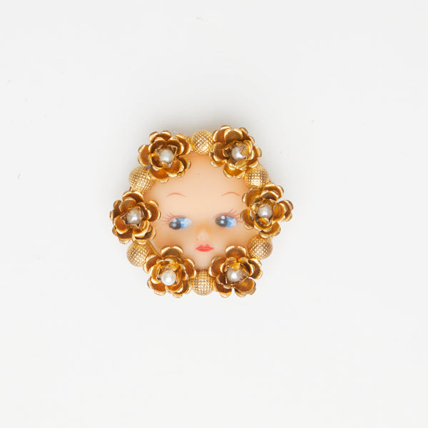 vintage doll face gold brooch with flower