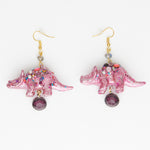 pink iridescent triceratops dinosaur earrings with purple gems