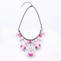 pink hello kitty necklace on plexiglass base