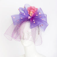 pink hair disco doll on purple bow hat headpiece with net