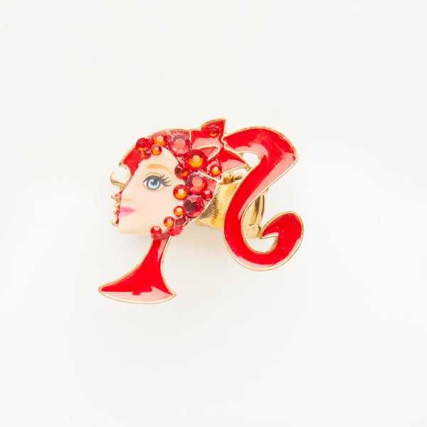 miniature profile doll face with iconic red pony tale