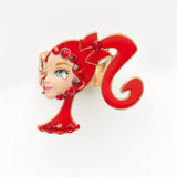 miniature profile doll face with iconic red pony tale