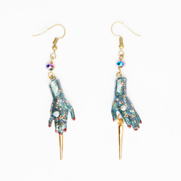 golden spike earrings with  glittery dolls hands
