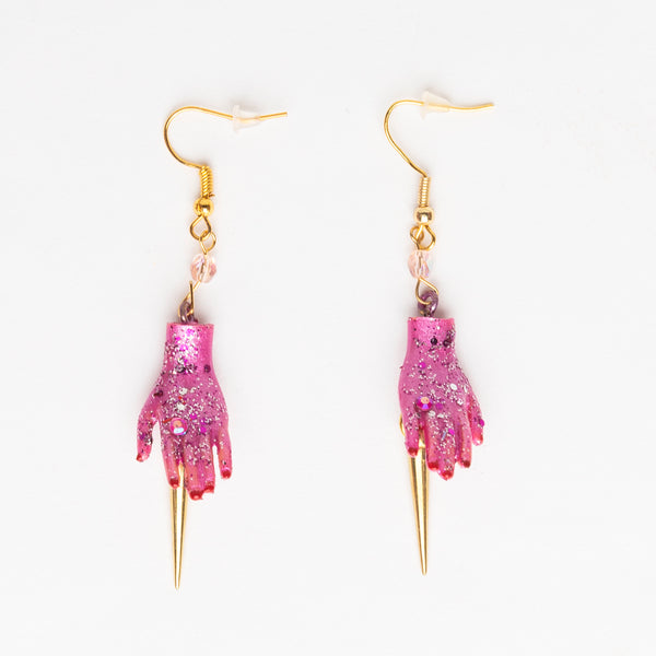 golden spike earrings with pink dolls hands