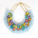 squishy monsters toys necklace with blue ruffle trim